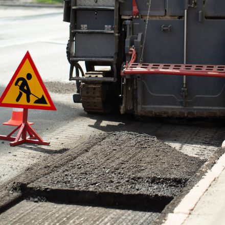 Asphalt repair. Fraser and road sign.